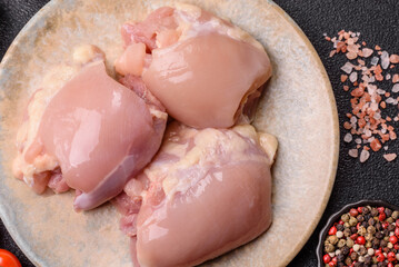 Raw chicken thigh fillet without skin and bone with salt and spices. Raw chicken fillet for cooking