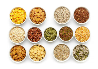 Various cereals, seeds, beans and grains in bowls isolated on white background
