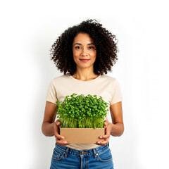 Woman demonstrates her hobby, holding a box of microgreens isolated on white