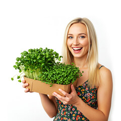 Woman demonstrates her hobby, holding a box of microgreens isolated on white