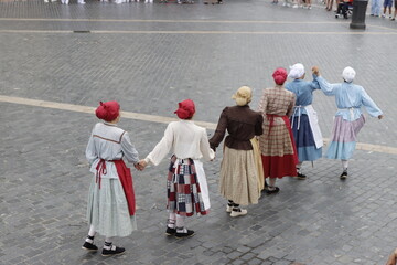 Basque folk dancers performing in traditional costume on the streets of Bilbao, Spain

