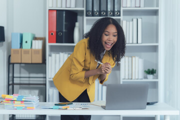 Excited Moment: An office scene of an excited woman celebrating a moment of success in the office.