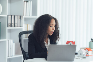 Businesswoman at Work: A focused and determined businesswoman is engrossed in her work, typing...