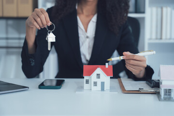 Home Ownership Deal: A professional figure confidently displays a set of house keys above a...