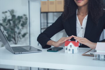 Real Estate Protection: A professional, showcasing a model house, symbolizing shelter, security,...
