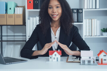 Real Estate Protector: An elegant professional, with hands outstretched to shield a miniature house...