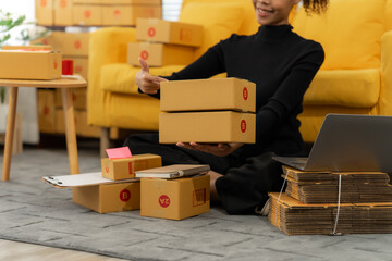 E-Commerce Setup: A person is joyfully setting up her e-commerce business with packages, ready to...