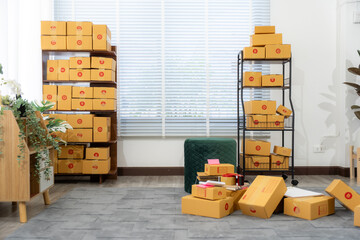Business owner Start up of enterprise small using laptop at workplace  small business entrepreneur SME or freelance working with a box at home deliver to customers, Online selling or e-commerce