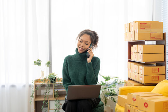 Business owner Start up of enterprise small using laptop at workplace  small business entrepreneur SME or freelance working with a box at home deliver to customers, Online selling or e-commerce