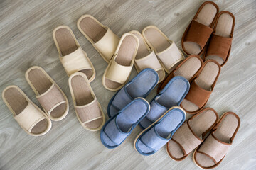 Cozy Comfort: Various slippers aligned on the floor represent relaxation and comfort, a perfect symbol of unwinding after a long day.