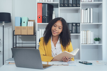 Focused Female in Modern Workspace: An attractive woman, exuding confidence, diligently studies a...