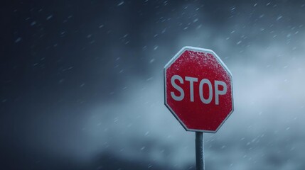 Close-up of a red stop sign with the word "stop" written in white capital letters. the sign is attached to a pole and is covered in snowflakes.