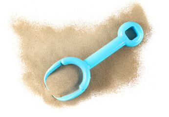 Plastic blue shovel, beach toy for kids in sand, isolated on white background, top view