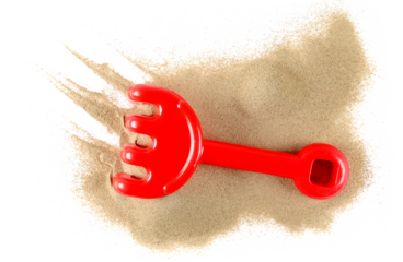 Plastic red rake, beach toy for kids in sand, isolated on white background, top view