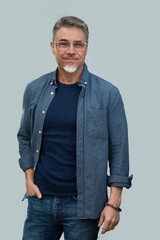 Casual mid adult man standing hand in pocket. Portrait of happy middle aged male in 50s with gray...