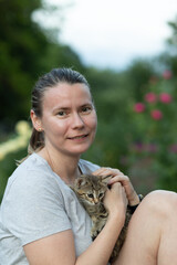 happy woman cuddling a kitten
