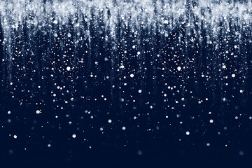 white glowing particles falling like snow over dark blue background with depth bokeh and dreamy atmosphere perfect for holiday winter celebration design or magical abstract themes