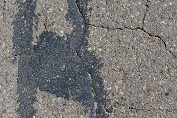 Damaged Asphalt Surface with Cracks and Patching