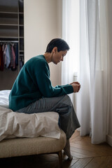 Procrastinating lonely woman after bad divorce news sit alone in bed staring down numb. Emotional...