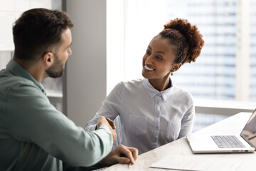 Happy African businesswoman, sales manager greeting company client, start consultation, formal...