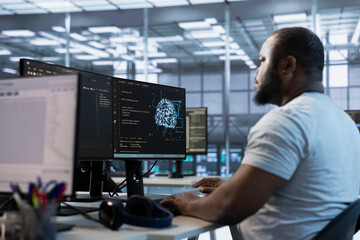 Admin working in server hub, sitting at computer desk, checking recovery plan, monitoring data...