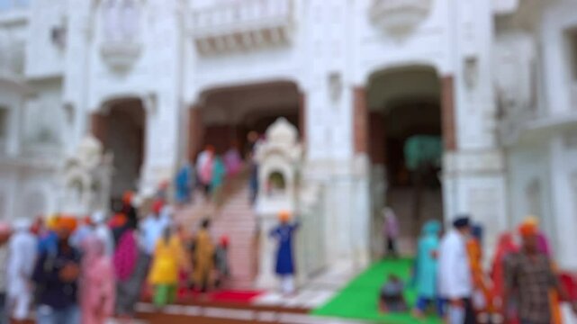 Bokeh view of devotees visiting Golden temple in Amritsar, India. Blurred background footage.