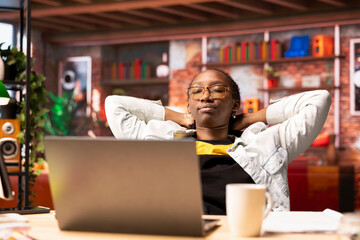 Woman in home office sleeping at desk, waiting for drank coffee to kick in before starting work on...