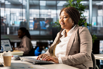 Businesswoman studying infographics and performance metrics for decision making, focused on project...