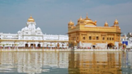 Bokeh view of Golden temple in Amritsar, India. Blurred background footage.