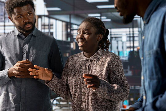 Female CEO leading a meeting with her team to find corporate strategy discussions, focusing on financial objectives and aligning performance metrics. African american company staff at the office.