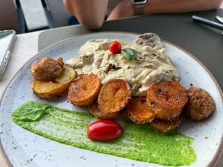 Beef Stroganoff with mushrooms and fried round potatoes