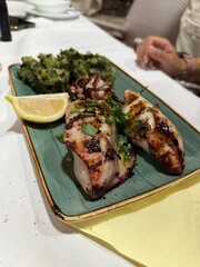 Baked squid stuffed with onions, carrots and mushrooms