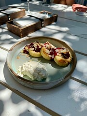 Cottage cheese pancakes with cream sauce and blueberries. syrniki