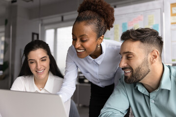Three multiracial workmates, team members brainstorm ideas for business campaign, analyze customer...