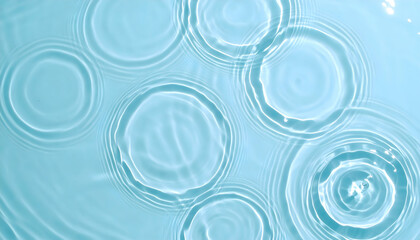 Serene Blue Water Surface with Concentric Ripples and Subtle Light Reflections