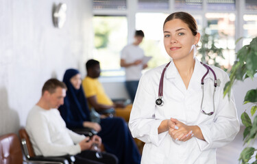 Portrait of young female doctor with a stethoscope in the lobby of a medical clinic
