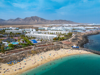 Playa Dorada beach in Playa Blanca from drone, Lanzarote, beach, turquoise sea and volcanes