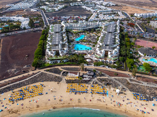 Playa Dorada beach in Playa Blanca from drone, Lanzarote, beach, turquoise sea and resort