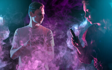 Young man and woman surrounded by colorful vape smoke, vaping electronic cigarettes, nightlife...