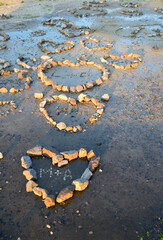 Stones on the beach laid out by lovers in the shape of hearts
