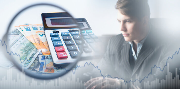 Business analyst with financial charts, calculator, and money under magnifying glass, focused on economic calculations. - Finance. Investment. Analytics.