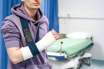 Close-Up Of Arm Cast In Sling Near Hospital Bed
