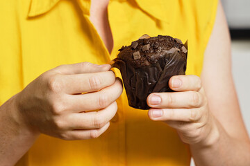 Hands Unwrapping Chocolate Muffin Before First Bite