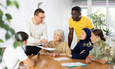 Men and women different ages discussion during business course