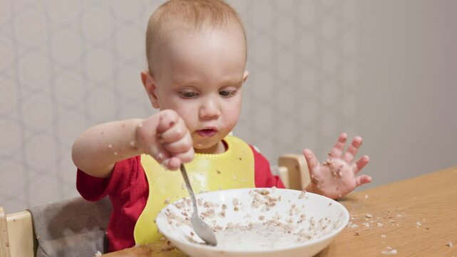 A joyful and playful baby is having breakfast, creating a delightful and colorful mess while exploring food