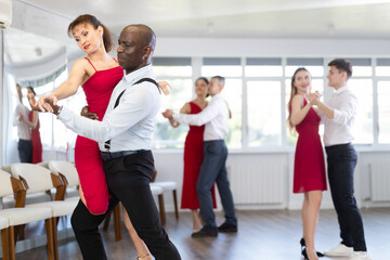 Woman paired with African American man practices movements of hali gali dance and trains to perform...