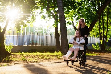 Girl in wheelchair (broken leg) and mom laugh at sunset. Universal clip for parenting, disability...