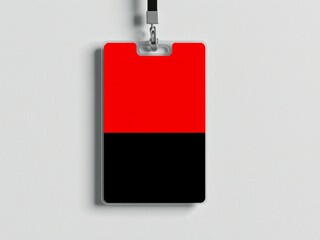 A red and black id badge hanging on a lanyard against a plain white background in a studio setting