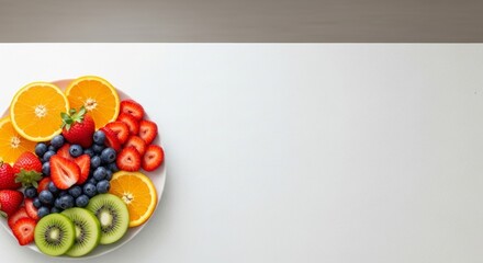 Vibrant fruit platter featuring oranges, strawberries, blueberries, and kiwi slices