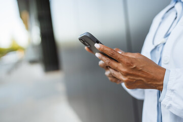 close up on african american female hands use cellphone outdoor